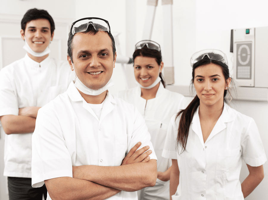 Dental team smiling in a clinic.
