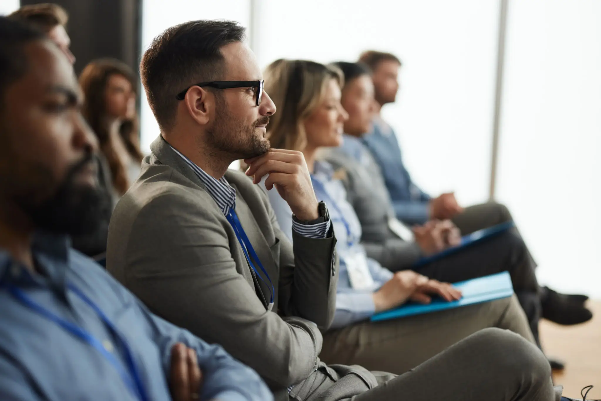 A man attentively listening during a professional meeting.