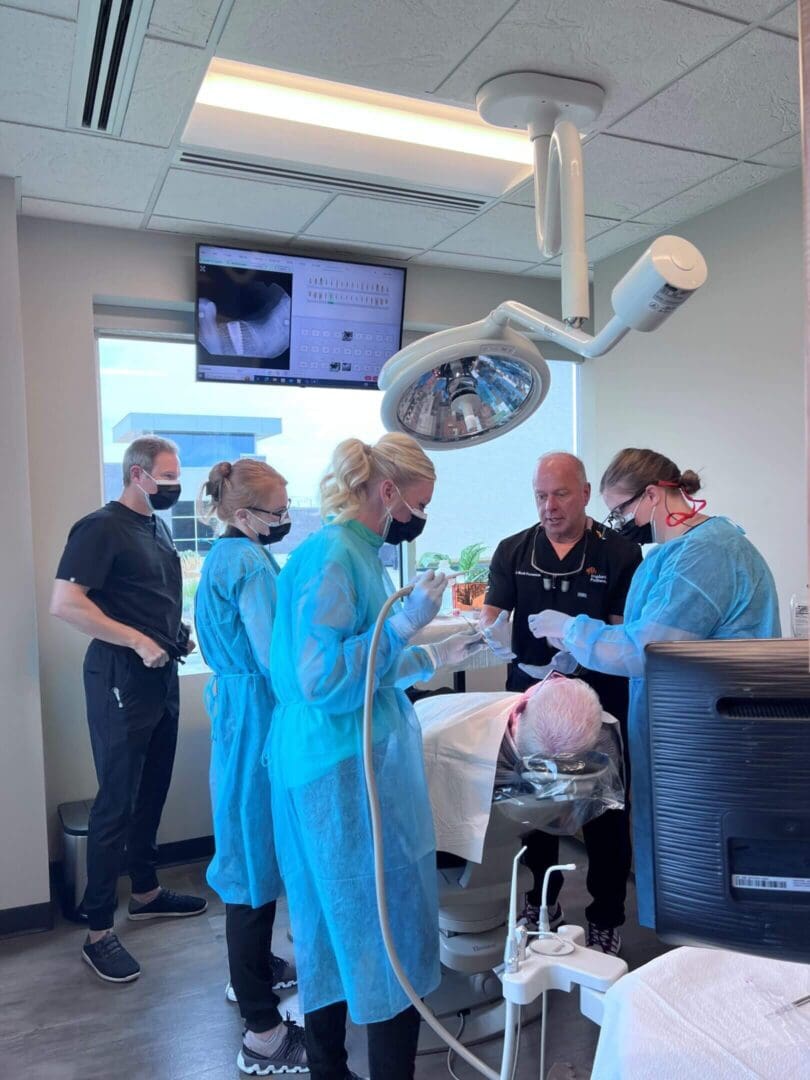 Dental team performing a procedure in a clinic.