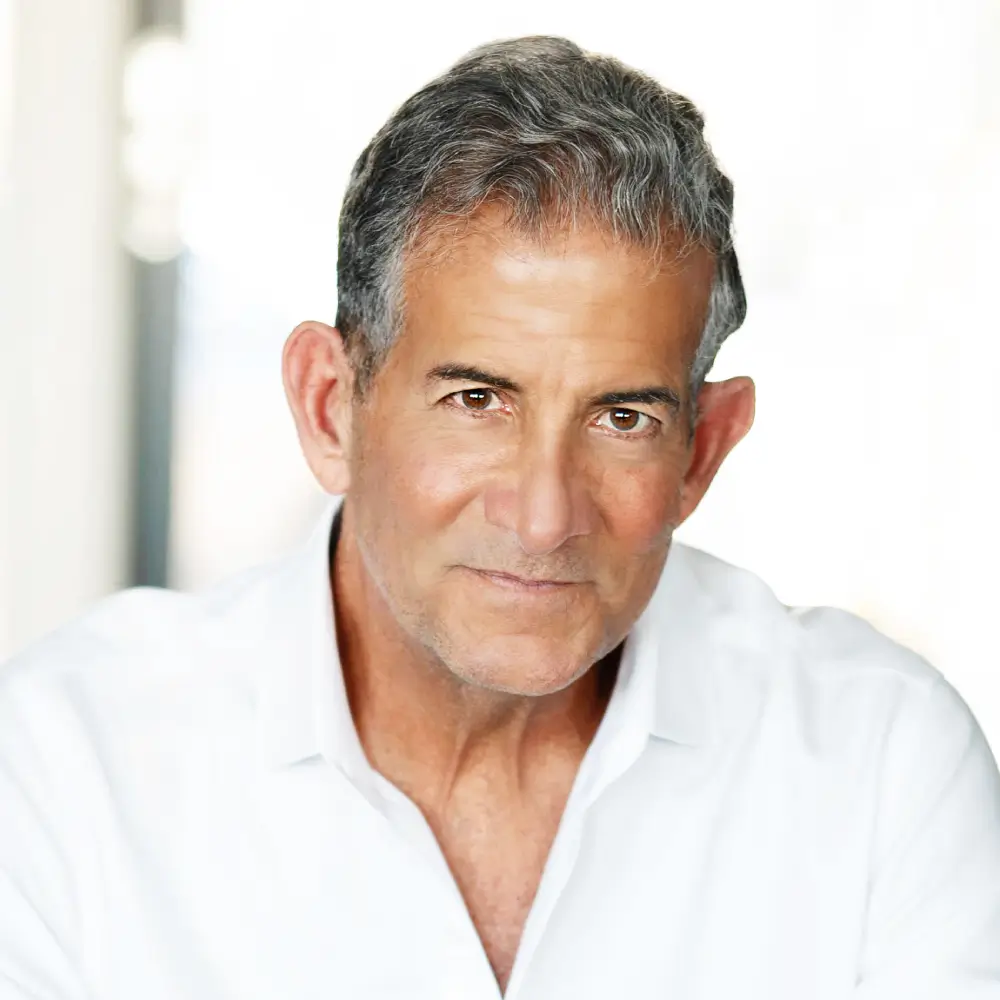 Middle-aged man in a white shirt looking confidently.