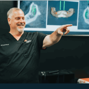 A dentist explaining dental X-rays to a patient.