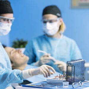 Dental team performing procedure with instruments