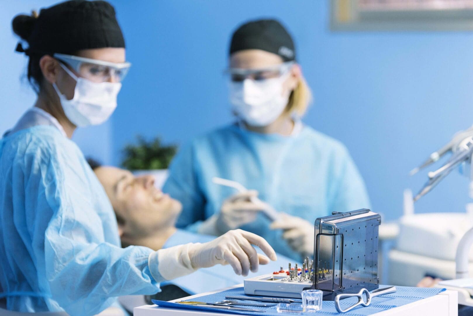Dental team performing procedure with instruments